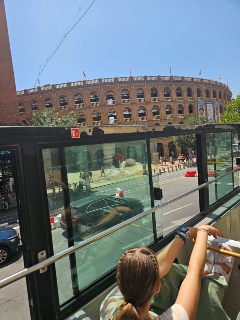 Enjoying the sunshine and views from a Hop on Hop off Bus tour in Valencia, Spain
