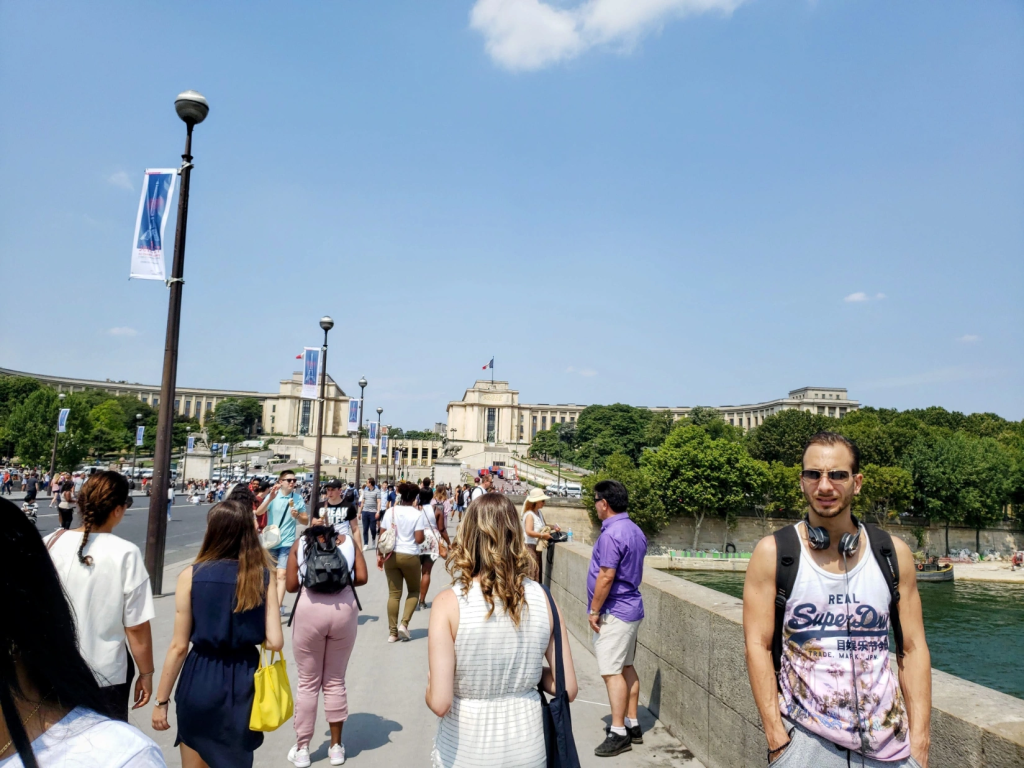 Sara walking along the bridge Pont d'Iéna by Eiffel Tower in Paris France
