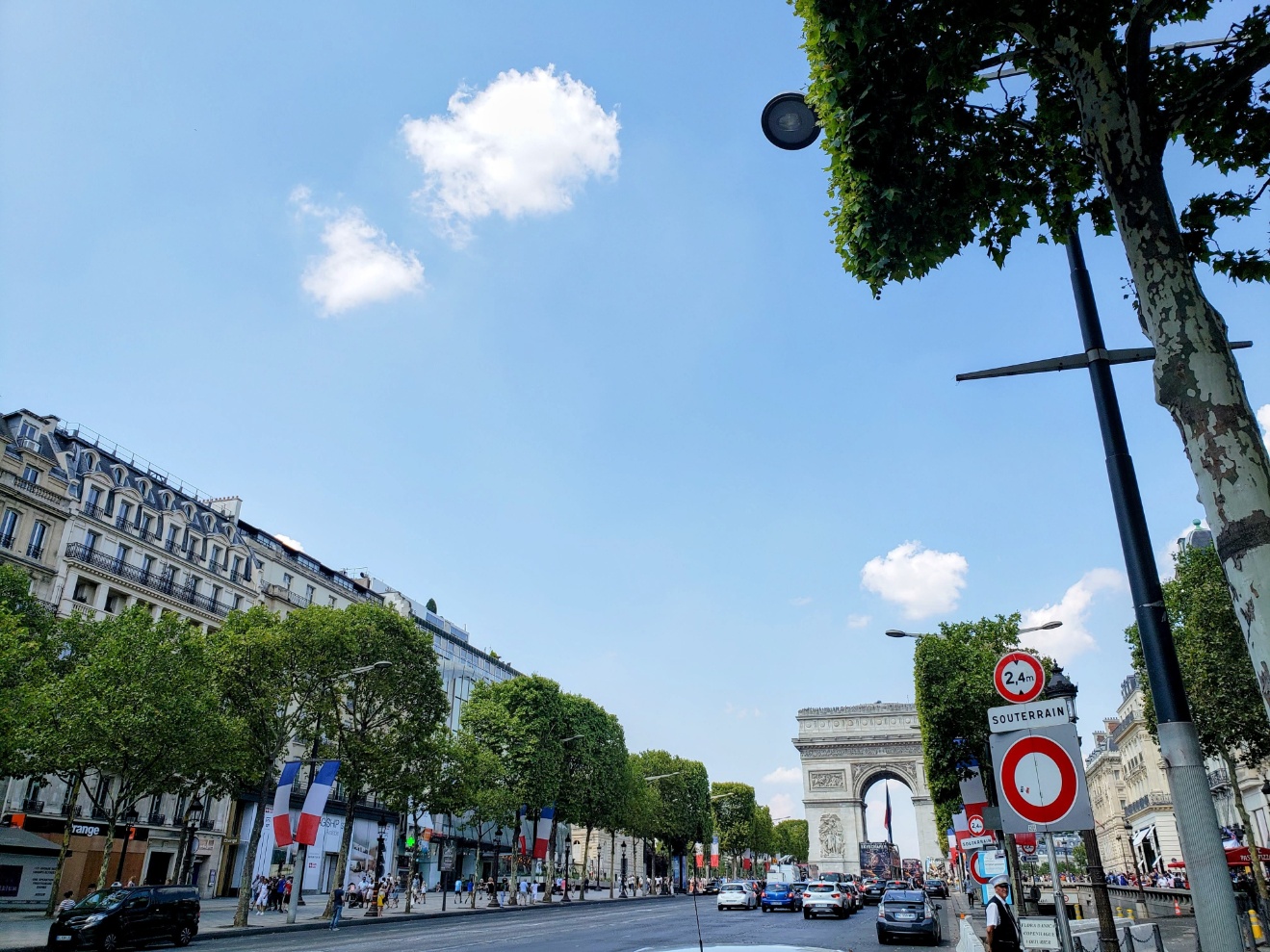 View of Arc de Triomphe while walking on the Champs-Élysées