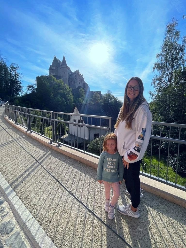 Millie and Sara from Atlas Adventured standing in front of Vainden Castle in Vainden, Luxembourg